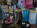 many bags of clothing on the shelves in the store