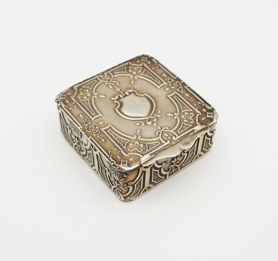 an antique silver box on a white surface with a white background