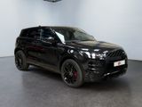 a black land rover is parked in a large room