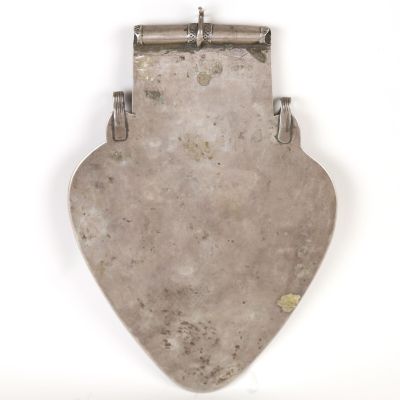 an antique silver plate with a metal handle on a white background