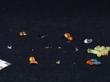 a close up of a bunch of small pieces of glass on a black surface
