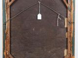 an old wooden frame with a tag hanging on it