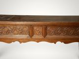 an image of a wooden table with carvings on the top of it