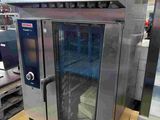 an image of a stainless steel oven in a warehouse