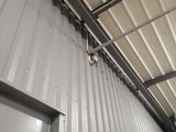 a metal building with a door and a light on it