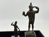 a small statue of a man and a small statue of a woman