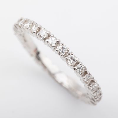 a close up of a diamond ring on a white background