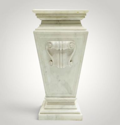 an image of a white marble vase with a face on it