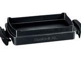 a close up of a black grill pan on a white background