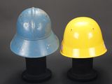 two helmets sitting next to each other on a black surface