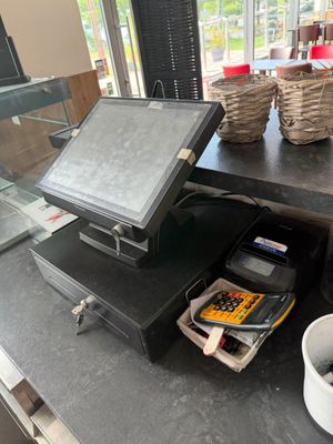 une image représentant une caisse enregistreuse et une tasse de café