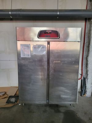 a picture of a double door refrigerator in a garage