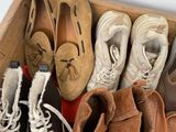 several pairs of shoes are lined up in a wooden box