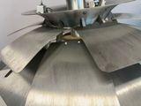 a close up of a metal fan on a table