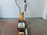 a small lawn mower that is sitting on the floor