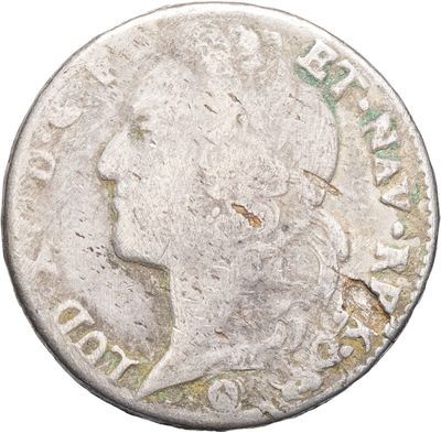 gros plan d'une pièce de monnaie sur laquelle figure une tête de femme