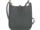 a black leather cross body bag with two gold handles
