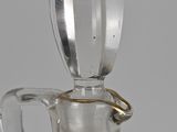 a clear glass pitcher with a gold ring on it