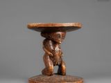 a wooden table with a monkey holding a bowl on top of it