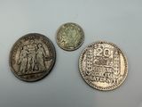 three different coins sitting on top of a table next to each other