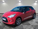 a red citrole is parked in a room with a checkered floor