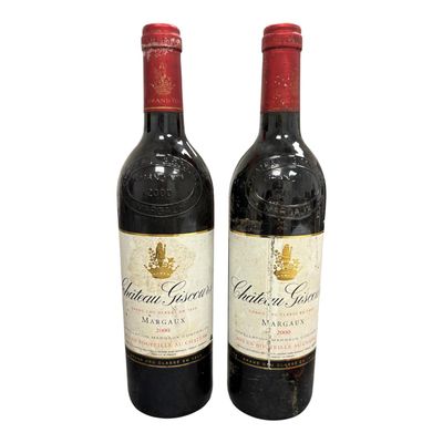 two bottles of red wine sitting next to each other on a white surface