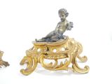 two figurines sitting on top of a table