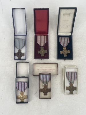 four medals and a medal in a case on a white surface
