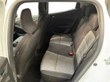 the back seats of a white car with a red button in the center