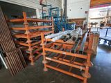 a rack of pipes in a warehouse with pallets in the background