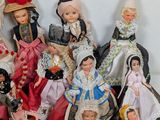 a lot of dolls that are sitting together on a table