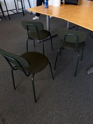 tables and chairs in a conference room with a laptop on the table