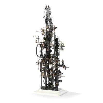 a sculpture of a tower made out of pipes and wires