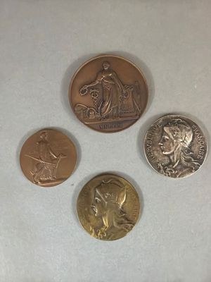 four different types of coins sitting on top of a white surface