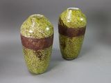 two vases sitting side by side on a gray surface