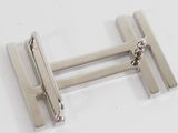 pair of silver plated cufflinks on a white surface
