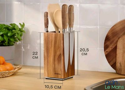 wooden utensils and knives in a wooden holder on a kitchen counter
