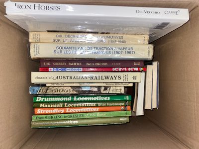 many books in a box that are stacked on top of each other