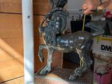 a bronze statue of a boy riding a horse