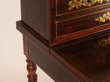 a small desk with a drawer on top of it