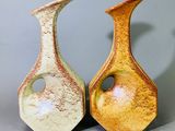 deux vases posés l'un à côté de l'autre sur une table