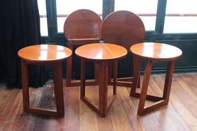 trois chaises en bois placées les unes à côté des autres sur un parquet en bois massif
