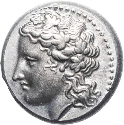 a close up of a silver coin with a woman ' s head on it
