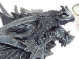 a statue of a dragon with a coin in it ' s mouth
