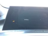 a laptop computer sitting on top of a car dashboard