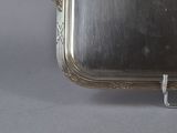 a silver tray that has a handle on it