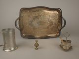a silver tray with a silver cup and a silver tray with a silver cup