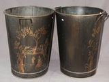 two metal buckets that are sitting next to each other