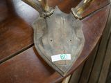 a wooden table with a deer ' s head on top of it