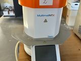 an orange and white machine sitting on top of a wooden table